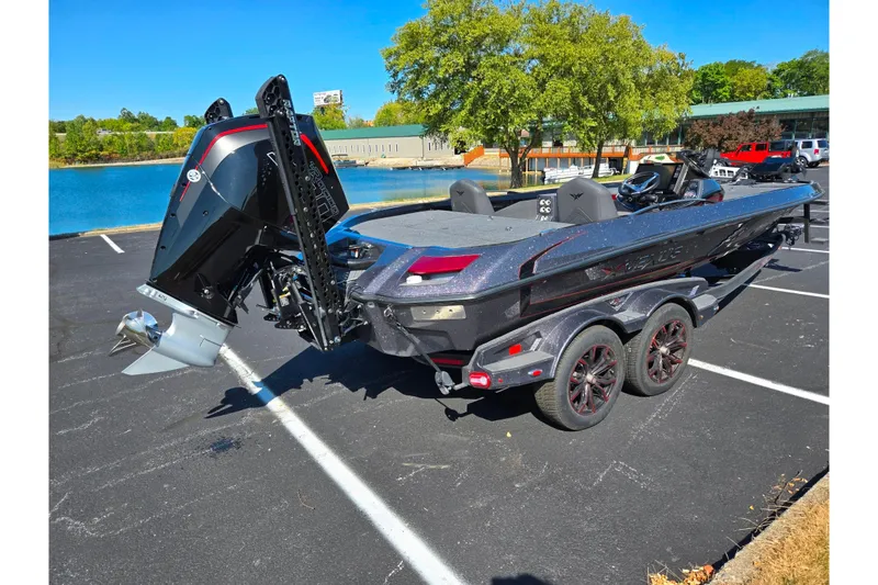 Slide: The Image of 2025 Vexus VX21 boat in parking lot near water, showcasing sleek design and powerful engine. - 10