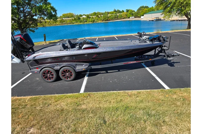 Slide: The Image of 2025 Vexus VX21 boat parked near a scenic lake on a sunny day. - 11