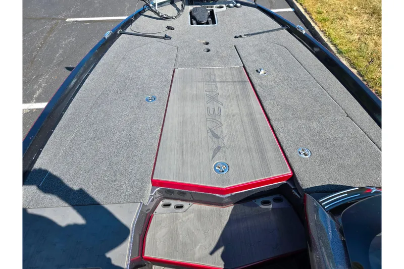 Slide: The Image of 2025 Vexus VX21 boat deck with gray carpeting and red accents. - 12