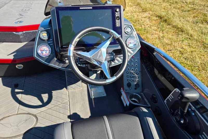 Slide: The Image of 2025 Vexus VX21 boat cockpit with steering wheel, control panel, and navigation display. - 16