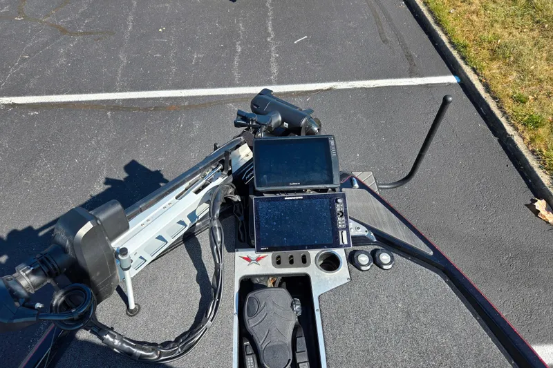 Slide: The Image of 2025 Vexus VX21 boat dashboard with electronic displays and controls on asphalt surface. - 20