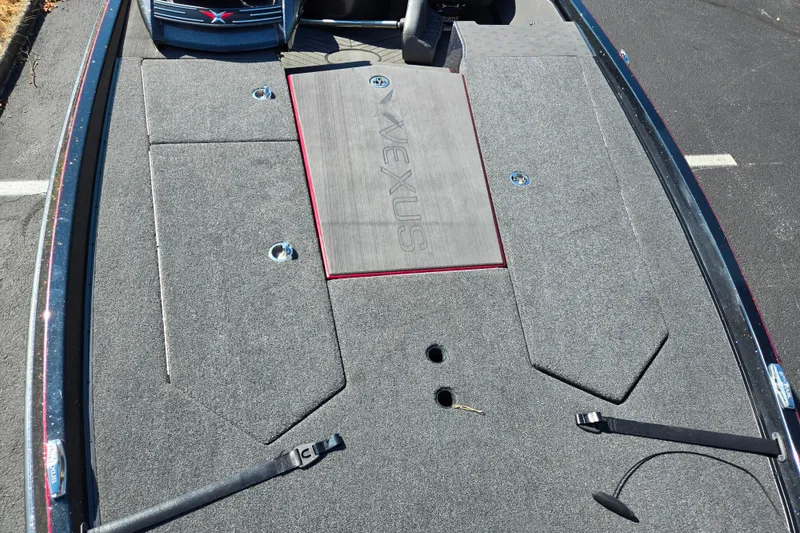 Slide: The Image of 2025 Vexus VX21 boat deck with carpeted surface and storage compartments. - 21