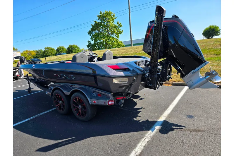 Slide: The Image of 2025 Vexus VX21 boat on trailer, parked outdoors, featuring sleek design and powerful engine. - 8
