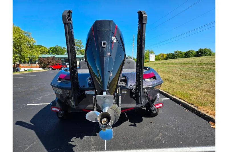 Slide: The Image of 2025 Vexus VX21 boat rear view with outboard motor in parking lot. - 9