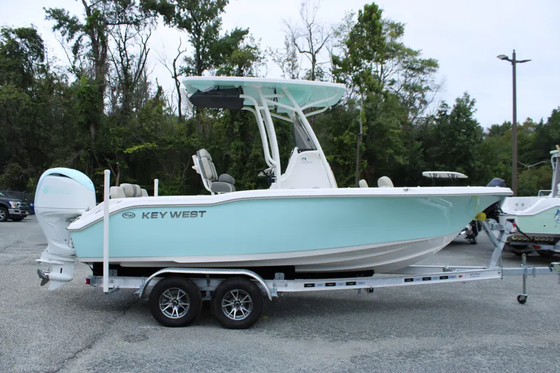 Slide: The Image of 2026 Key West 219 FS boat on trailer, parked outdoors. - 1