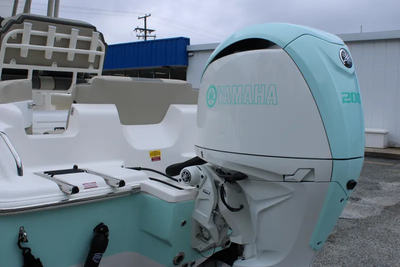 Slide: The Image of 2026 Key West 219 FS boat with Yamaha 200 outboard motor, docked outdoors. - 10