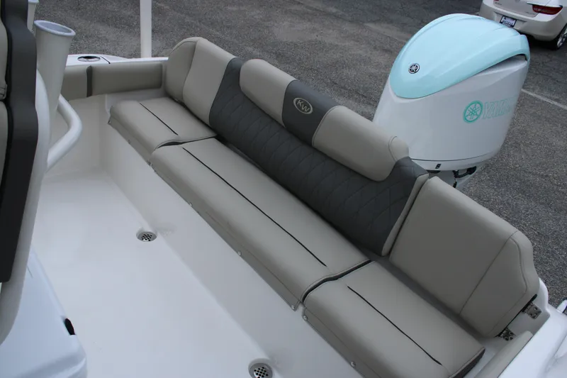 Slide: The Image of 2026 Key West 219 FS boat with cushioned seating and Yamaha outboard motor. - 13