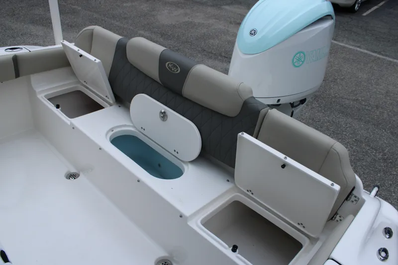 Slide: The Image of 2026 Key West 219 FS boat interior with storage compartments and Yamaha engine. - 14