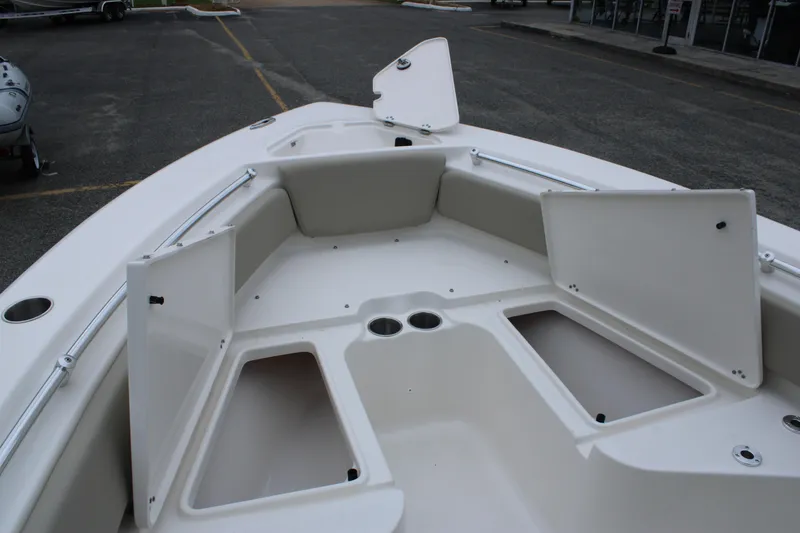 Slide: The Image of 2026 Key West 219 FS boat interior with open storage compartments and cup holders. - 16