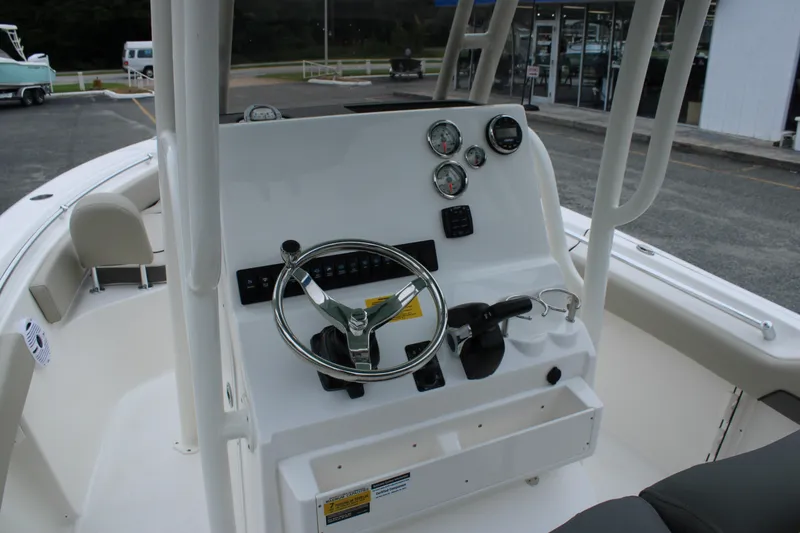 Slide: The Image of 2026 Key West 219 FS boat dashboard with steering wheel and gauges. - 18
