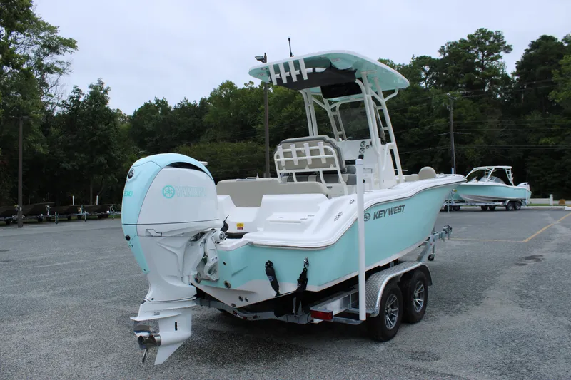 Slide: The Image of 2026 Key West 219 FS boat on trailer, featuring Yamaha outboard motor, parked outdoors. - 2