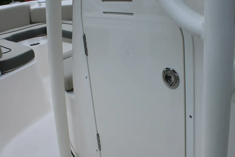 Slide: The Image of 2026 Key West 219 FS boat interior, featuring a sleek white door and seating area. - 29