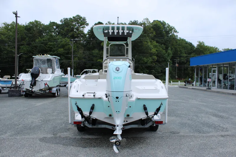 Slide: The Image of 2026 Key West 219 FS boat displayed in a dealership lot, rear view. - 3