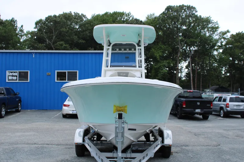 Slide: The Image of 2026 Key West 219 FS boat on trailer, parked outside blue building. - 7