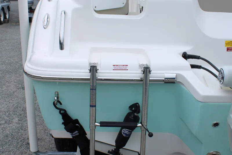 Slide: The Image of 2026 Key West 219 FS boat stern with ladder and teal hull. - 8