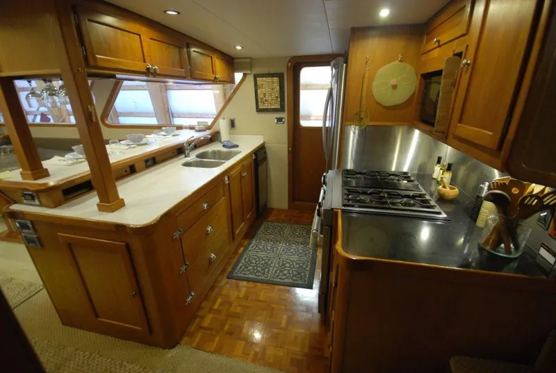 Slide: The Image of 1980 Willard Marine Pilothouse kitchen with wooden cabinetry and modern appliances. - 10