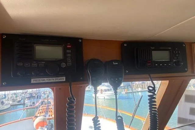 Slide: The Image of 1980 Willard Marine Pilothouse interior with communication radios and microphones, overlooking marina. - 14