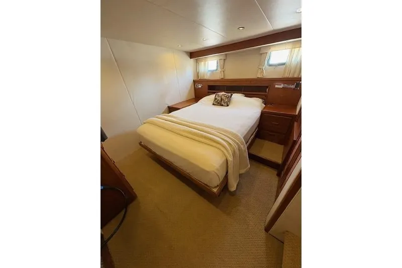 Slide: The Image of Cozy bedroom in 1980 Willard Marine Pilothouse with double bed and wooden furnishings. - 18