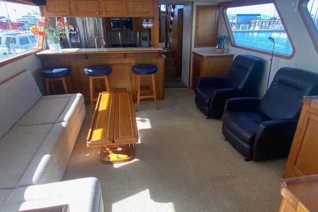 Slide: The Image of Luxurious 1980 Willard Marine Pilothouse interior with seating, bar stools, and large windows. - 2