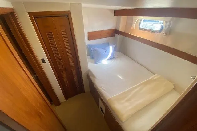 Slide: The Image of Cozy cabin interior of 1980 Willard Marine Pilothouse with bed and wooden accents. - 24