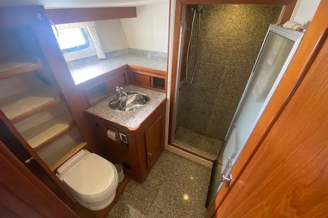 Slide: The Image of 1980 Willard Marine Pilothouse bathroom with shower, sink, and toilet. - 25