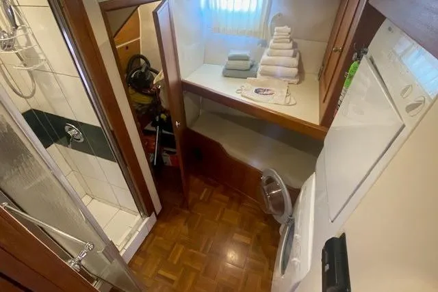 Slide: The Image of 1980 Willard Marine Pilothouse interior with shower, washer, and storage area. - 26