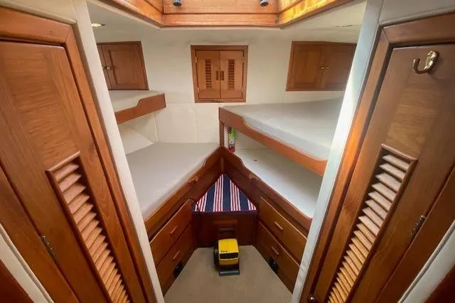 Slide: The Image of 1980 Willard Marine Pilothouse cabin interior with wooden finishes and twin beds. - 28