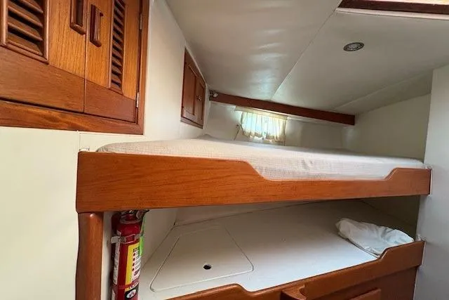 Slide: The Image of 1980 Willard Marine Pilothouse interior with wooden bunk beds and storage cabinets. - 29