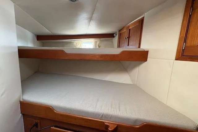 Slide: The Image of Interior cabin of 1980 Willard Marine Pilothouse with bunk beds and wooden storage. - 30