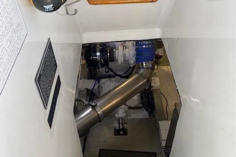 Slide: The Image of Engine room of a 1980 Willard Marine Pilothouse boat, showcasing mechanical components. - 32