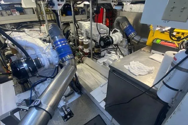 Slide: The Image of Engine room of a 1980 Willard Marine Pilothouse boat, showcasing mechanical components and equipment. - 34