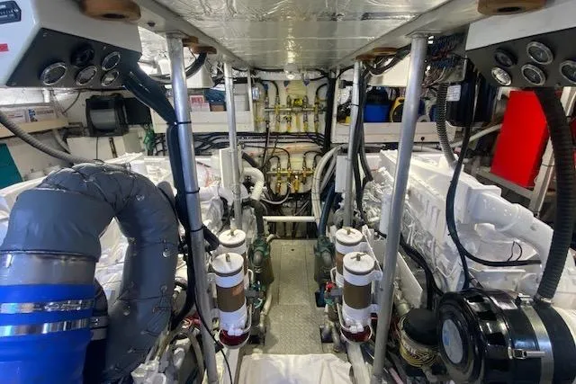 Slide: The Image of Engine room of a 1980 Willard Marine Pilothouse boat, showcasing machinery and equipment. - 37