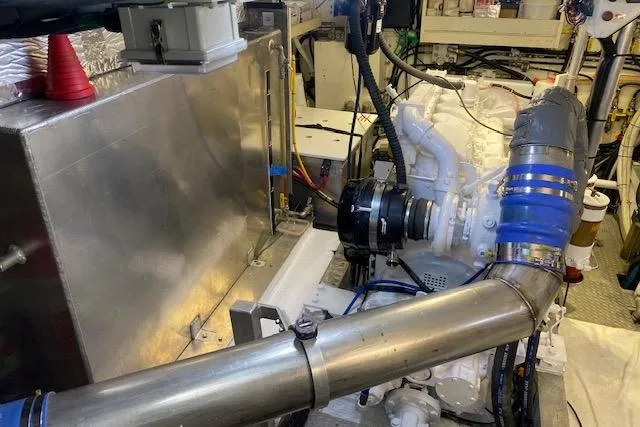 Slide: The Image of Engine room of a 1980 Willard Marine Pilothouse, showcasing mechanical components and piping. - 38