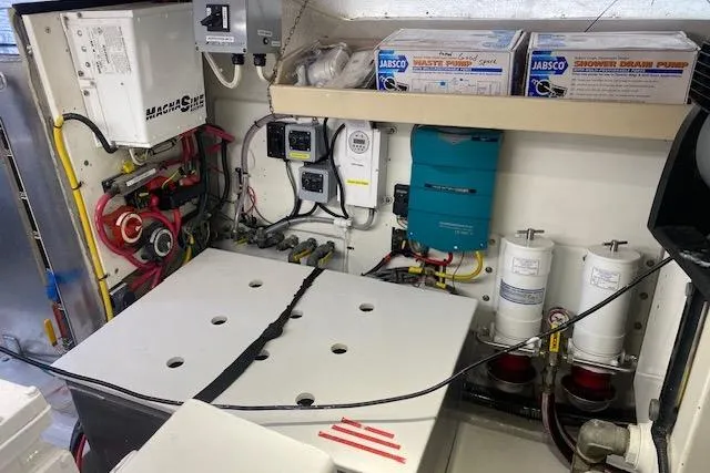 Slide: The Image of Engine room of a 1980 Willard Marine Pilothouse with various equipment and components. - 39