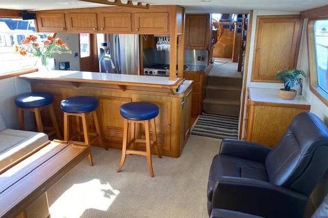 Slide: The Image of Interior of 1980 Willard Marine Pilothouse with bar, stools, and comfortable seating. - 4