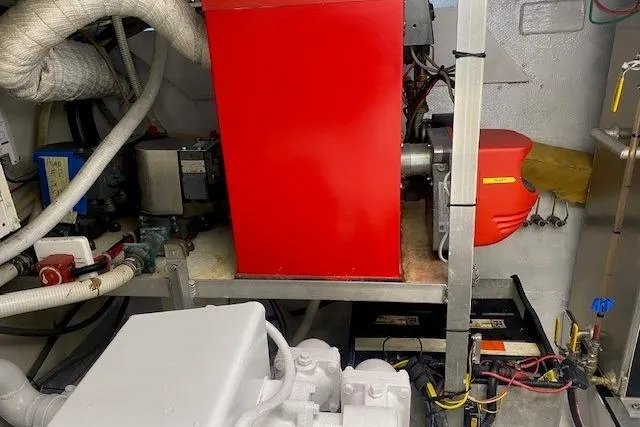 Slide: The Image of Engine room of 1980 Willard Marine Pilothouse with red machinery and wiring. - 40