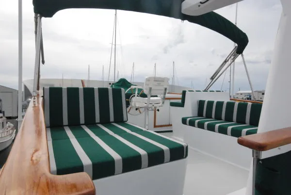 Slide: The Image of 1980 Willard Marine Pilothouse boat with green-striped seating and wooden accents. - 43