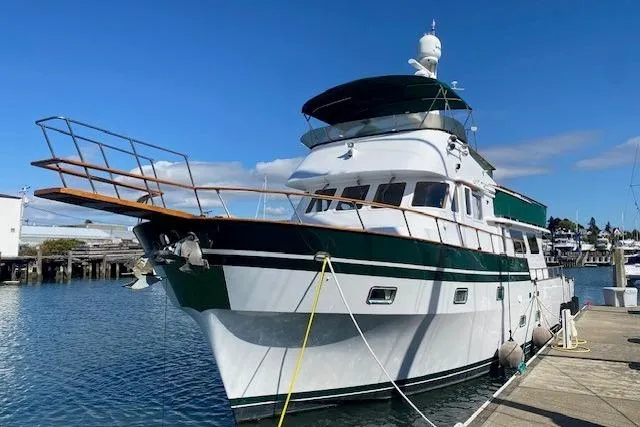 Slide: The Image of 1980 Willard Marine Pilothouse boat docked at a marina under clear blue skies. - 56