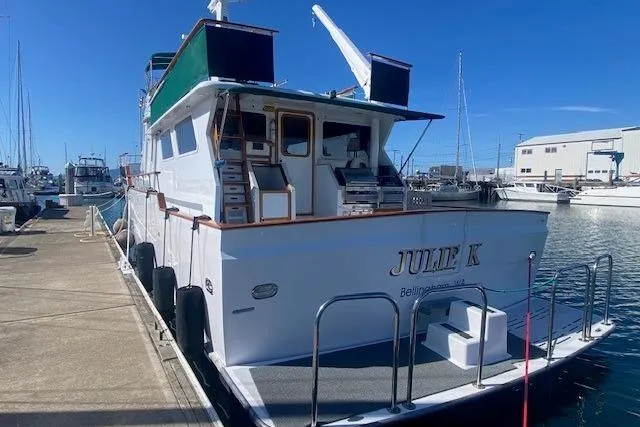 Slide: The Image of 1980 Willard Marine Pilothouse boat docked at a marina under clear blue skies. - 57
