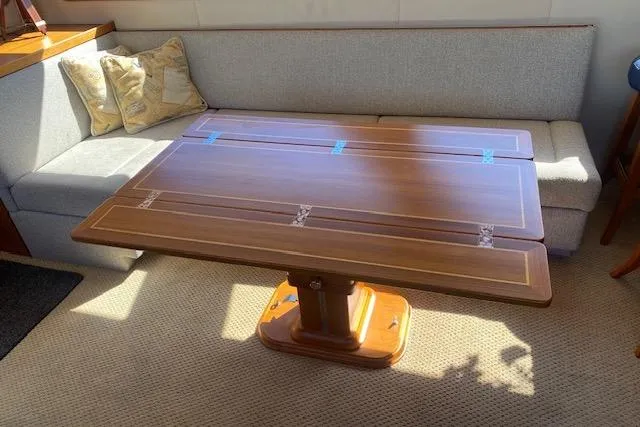 Slide: The Image of 1980 Willard Marine Pilothouse interior with wooden table and cushioned seating. - 7