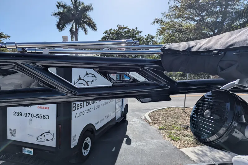 Slide: The Image of 2026 Trifecta 25RF SS boat detail with trailer and palm trees in background. - 11