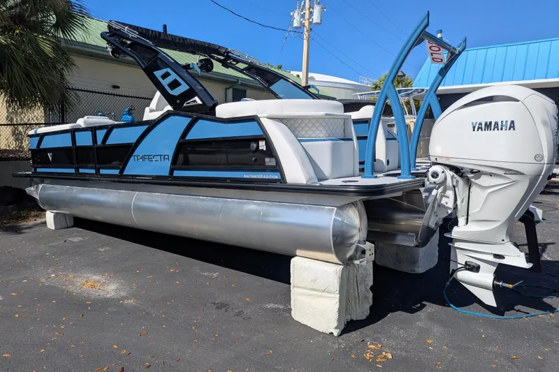Slide: The Image of 2026 Trifecta 25RF SS pontoon boat with Yamaha engine, displayed outdoors. - 3