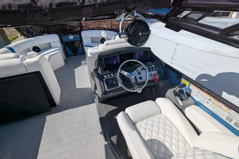 Slide: The Image of Luxurious interior of 2026 Trifecta 25RF SS pontoon boat with modern steering and seating. - 4