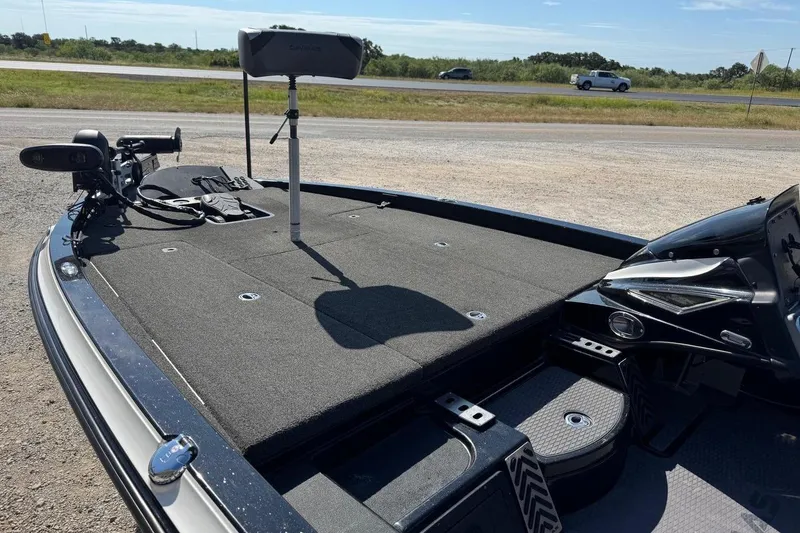 Slide: The Image of 2021 Caymas CX20 boat deck with fishing equipment, parked near a road. - 9