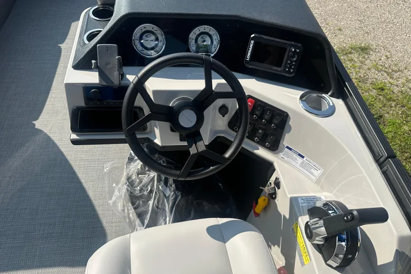 Slide: The Image of 2025 Crest Classic 220 boat dashboard with steering wheel and control panel. - 11