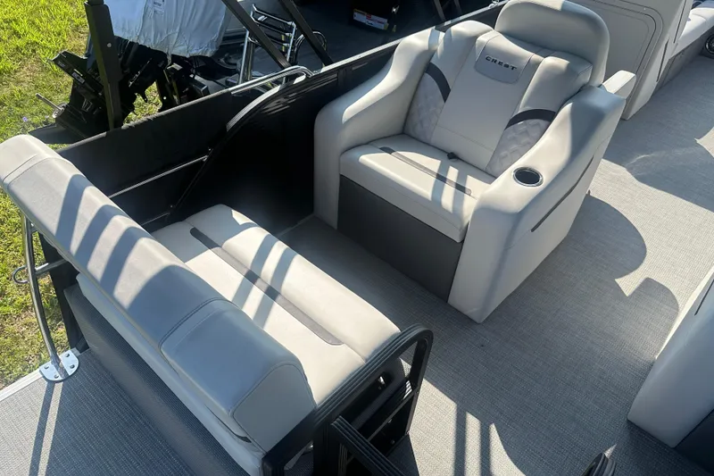 Slide: The Image of 2025 Crest Classic 220 boat interior with plush seating and cup holder. - 15
