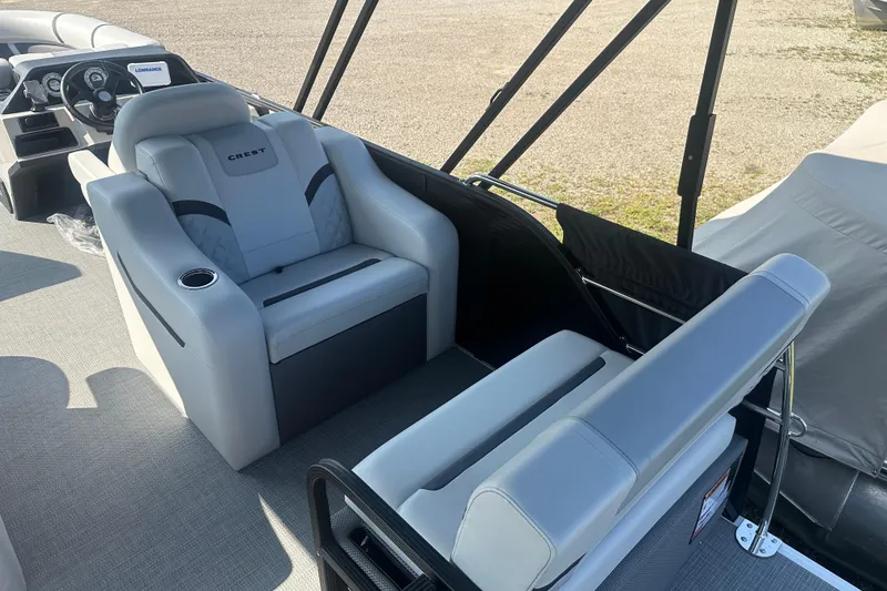 Slide: The Image of 2025 Crest Classic 220 boat interior with plush seating and modern design. - 16