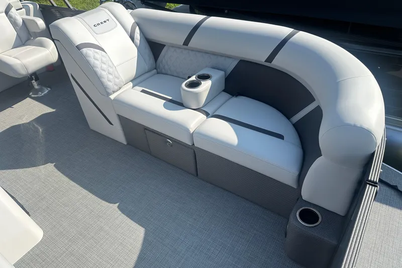 Slide: The Image of 2025 Crest Classic 220 boat interior with plush seating and integrated cup holders. - 5