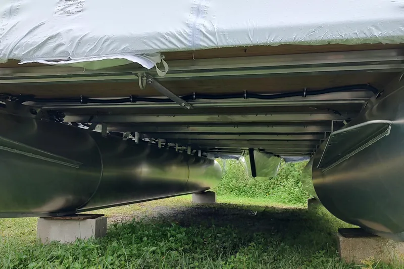 Slide: The Image of Underneath view of a 2026 Sylvan Mirage 820 PARTY FISH pontoon boat on blocks. - 16