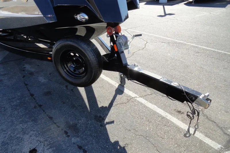 Slide: The Image of 2022 Heyday WT Surf boat trailer hitch and wheel on pavement. - 26